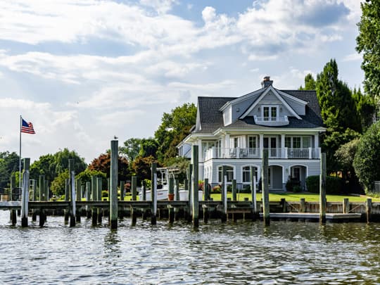 Lakefront-540 Beautiful Lakefront home with blue skies and fluffy clouds